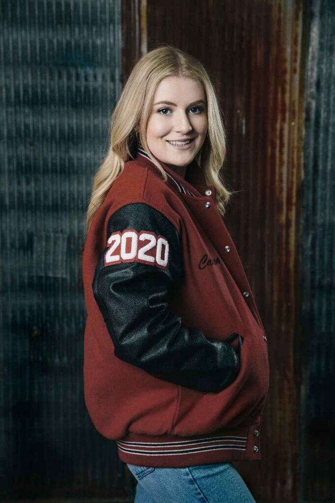 Girl wearing modern evolution of high school patch on jacket