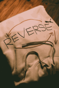 Stylish person in patterned outfit posing outdoors, showcasing fashion design.