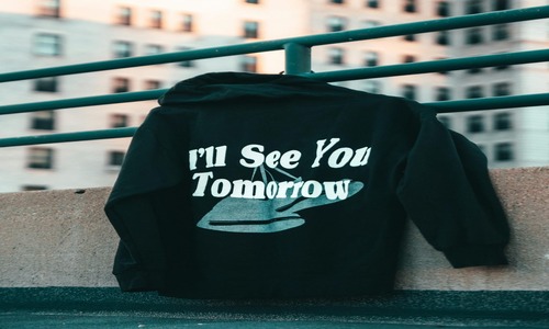 Black hoodie with 'I'll see you tomorrow' text on it, ideal for high-quality hoodies.