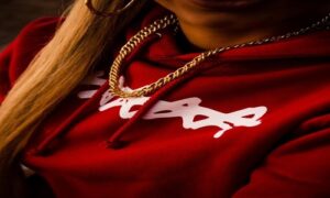 woman wearing gold-colored Cuban-chain necklace