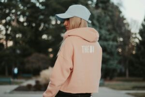 woman wearing orange pullover
