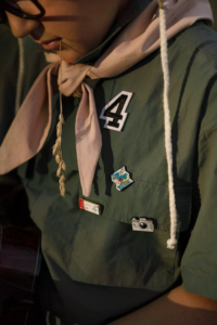 A number 4 patch on a green scout uniform, choosing colors and materials that stand out.