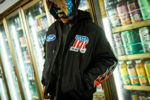 Man in a black graphic jacket exploring versatile options for modern school apparel.