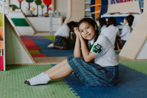 Schoolgirl with a logo patch on her sleeve to incorporate school logo patches for instant recognition