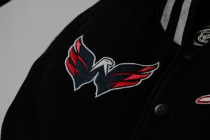 Embroidered eagle logo on a black jacket, choosing colors and shapes that create impact