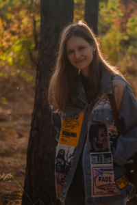 Woman in a denim jacket, showing how custom morale patches express personality.