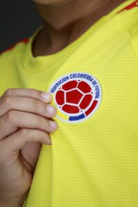Soccer emblem patch on a yellow jersey, prioritizing durability and proper application.